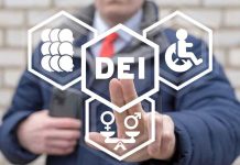 Person pointing at DEI symbols on glass.