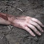 Pakistan Built the Taliban—Now Pays in Blood Injured arm partially buried in dirt.