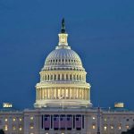 U.S. Capitol building illuminated at dusk.