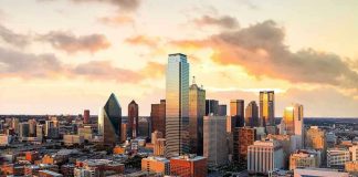 City skyline at sunset with modern skyscrapers.