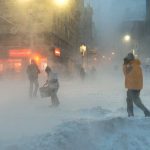 Five Forms of ID for Snow Duty—None for Voting People walking in a snowy urban street during a blizzard