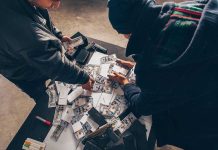 $3 Million Vanished — Through the Ceiling Two individuals handling stacks of money on a table.