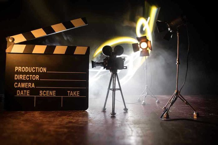 Film set with clapperboard, camera, and lighting.