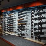 Wall-mounted guns displayed in a store.