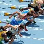 Athletes in starting position for a sprint race on a track