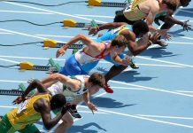 Athletes in starting position for a sprint race on a track