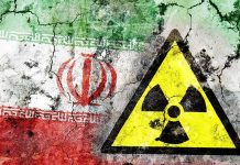 Iranian Spies BREACH Nuclear Sub Base A cracked wall featuring the Iranian flag and a nuclear warning symbol