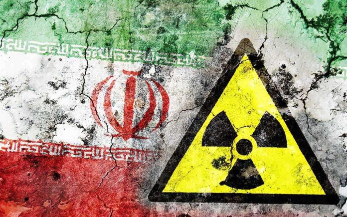 A cracked wall featuring the Iranian flag and a nuclear warning symbol