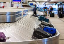 Luggage on a conveyor belt at an airport baggage claim area