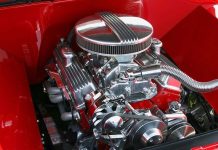 Close-up of a shiny chrome engine inside a red car