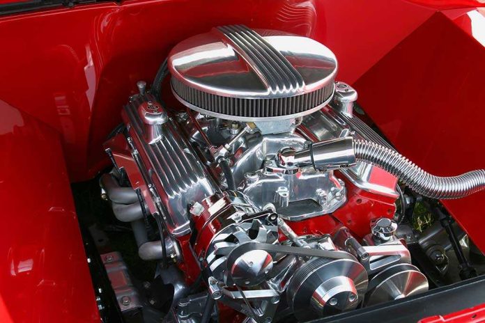 Close-up of a shiny chrome engine inside a red car