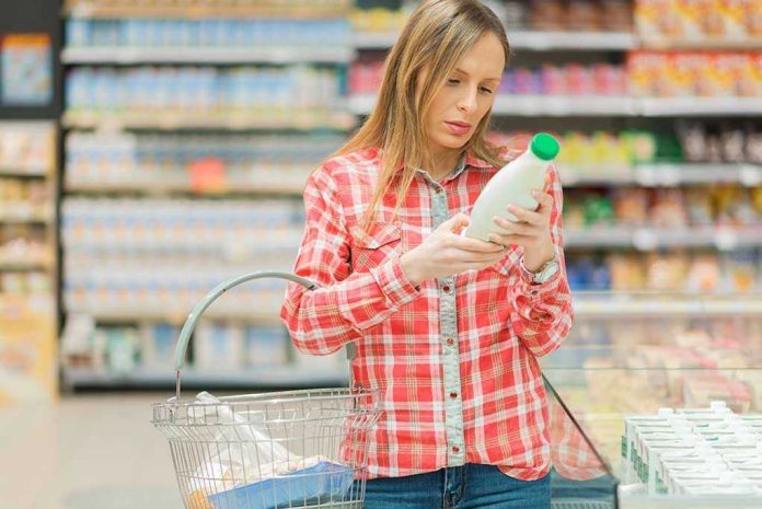 Woman examining a bottle in a grocery store
