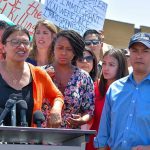 Group of people at an outdoor press event.