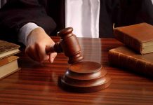 Judges gavel on desk with books.