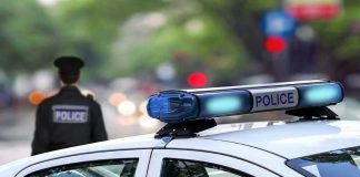 Gunshot Greets Cops At Child-Sex Call Police car and officer on a city street.