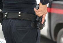 Person holding a gun in a holster.