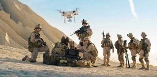 Combat Assets Hijacked—To Save Abandoned Animals Soldiers operating a drone in a desert environment.