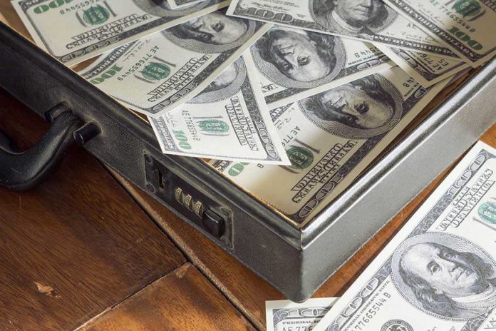 A briefcase filled with hundred dollar bills on a wooden surface