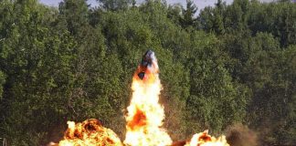 Strike Torches Russia’s Billion-Dollar War Chest A large explosion with flames and smoke in an outdoor setting