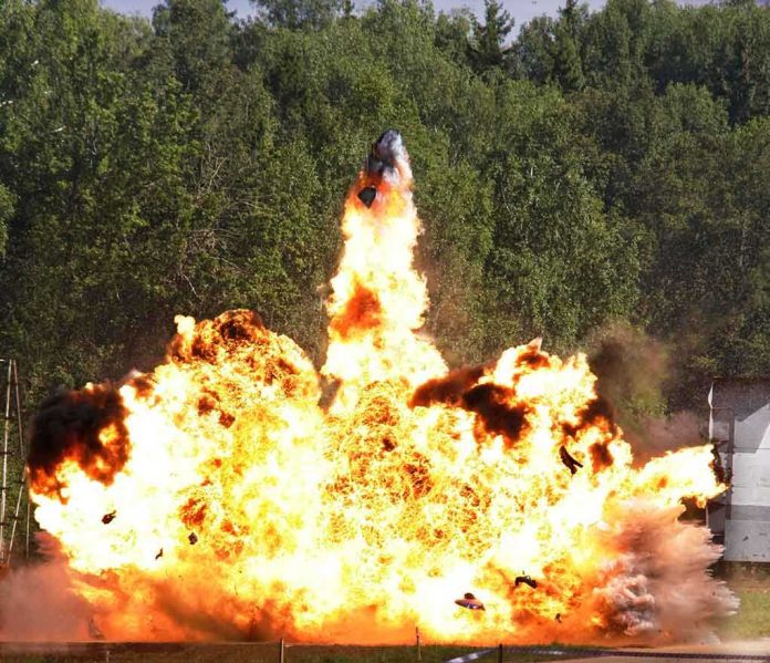 shutterstock_68754286.jpg A large explosion with flames and smoke in an outdoor setting