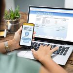 Trump Order Personal Bank Account’s SHAKE-DOWN! Person using online banking on laptop and smartphone.