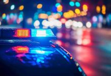 Police car with flashing lights at night.