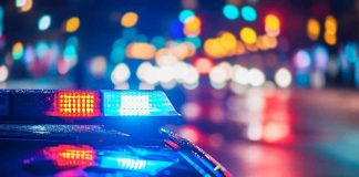 Woke Mayor Calls His Police Dept a SICKNESS! Police car with flashing lights at night.