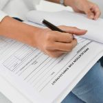Stunning Decline: 1 in 3 U.S Men UNEMPLOYED Person filling out job application form.