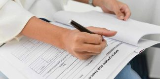 Stunning Decline: 1 in 3 U.S Men UNEMPLOYED Person filling out job application form.