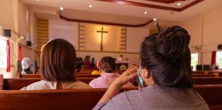 Catholic Church Files BANKRUPTCY After Settlement Payments People sitting in church pews during service.