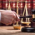 Felon SWAPS Gender Last-Minute Sparking Legal Uproar Judge's hand holding gavel near scales of justice