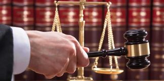 Felon SWAPS Gender Last-Minute Sparking Legal Uproar Judge's hand holding gavel near scales of justice