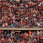 Crowd of fans filling stadium seats