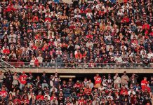 Crowd of fans filling stadium seats