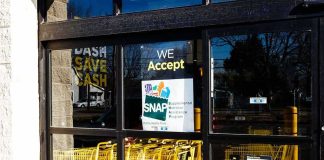 America’s WORST Welfare State Revealed Store entrance with yellow shopping carts behind glass doors