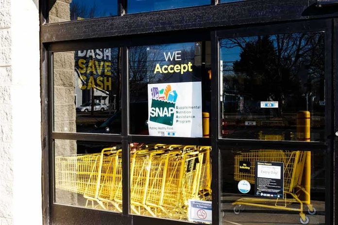 shutterstock_1346649863 Store entrance with yellow shopping carts behind glass doors