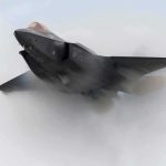 Stealth fighter jet piercing a vapor cloud
