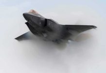 Stealth fighter jet piercing a vapor cloud