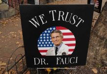 yard sign with portrait of a doctor over a U.S. flag