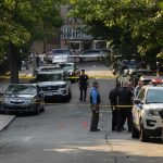 Islamization Now WORSER Threat Than Gangs Police officers secure a residential street with patrol cars and yellow tape