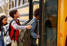 Children boarding a yellow school bus