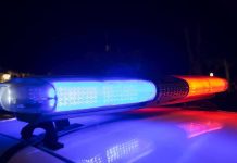 Police car light bar flashing blue and red at night