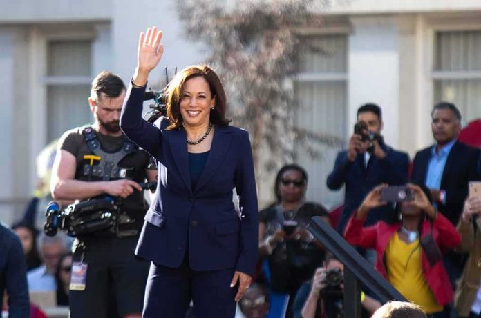 woman in navy suit waving at outdoor event