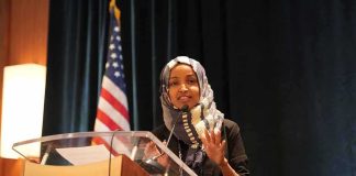 Ilhan Omar’s Political Future Decided After Primary Vote Woman in hijab speaking at a podium
