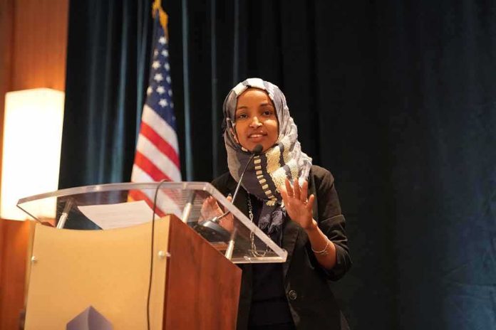 Woman in hijab speaking at a podium