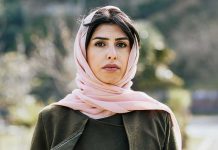 Woman in a pink headscarf outdoors
