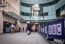 People walking outside the BBC building entrance