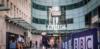People walking outside the BBC building entrance