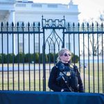 Secret Service Purged Over Confidential Trump Leak Security officer stands guard outside a large white government building