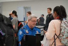 tsa officer checks a traveler's documents at airport security